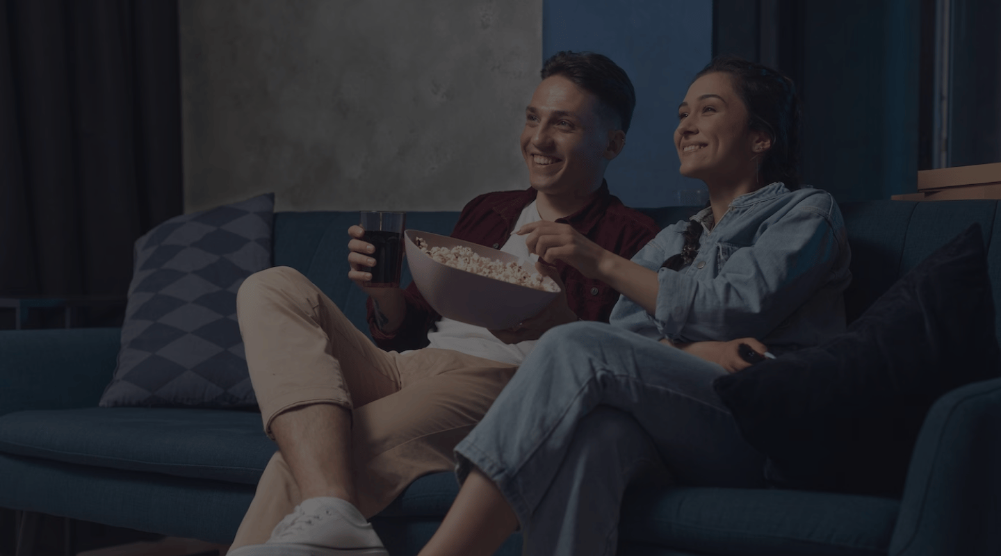 Apollo Group TV — a couple streaming their favorite HD content on the couch, anytime, anywhere, any screen